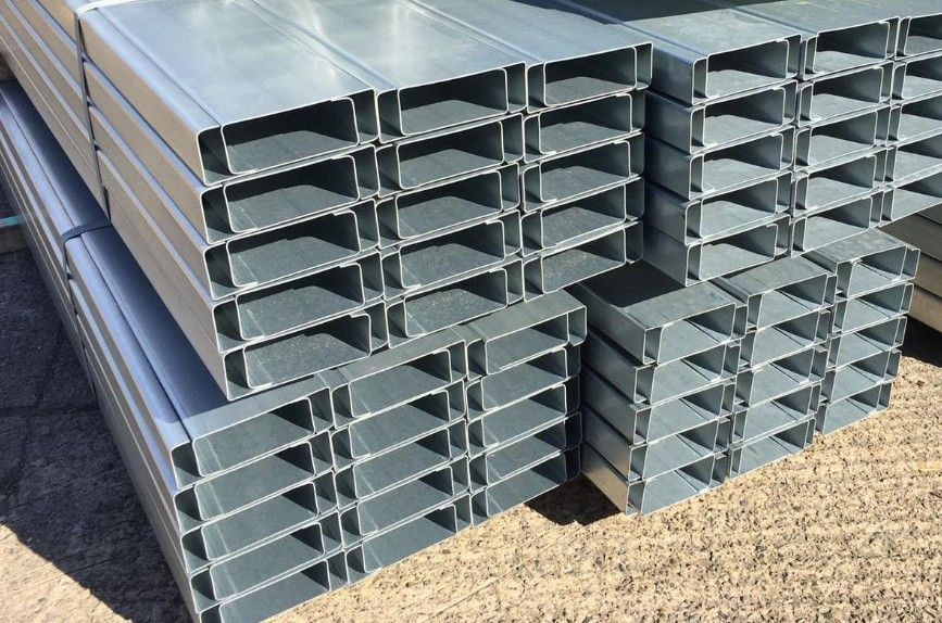 A stack of metal tubes sitting on top of each other on the ground.