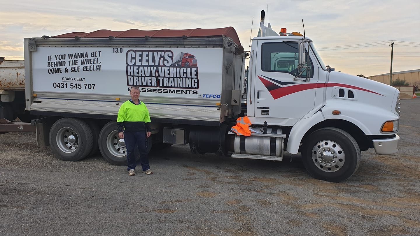 Man With a Green Shirt and His Truck — Ceely's Heavy Vehicle Driver Training & Assessments In Wagga Wagga, NSW