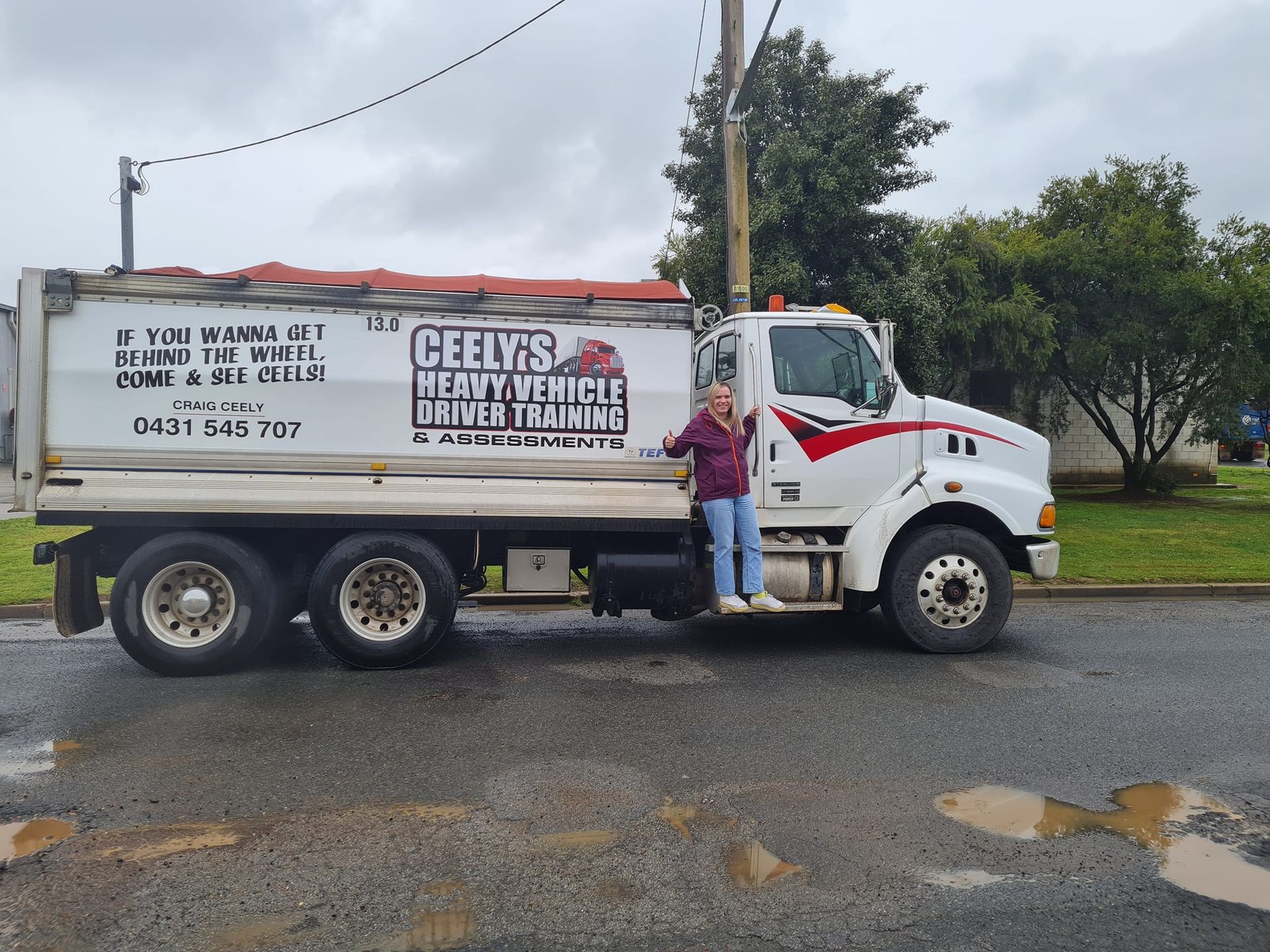 Blonde Lady on Step of Truck — Ceely's Heavy Vehicle Driver Training & Assessments In Wagga Wagga, NSW