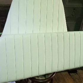 Un cojín blanco está sobre una mesa de madera.