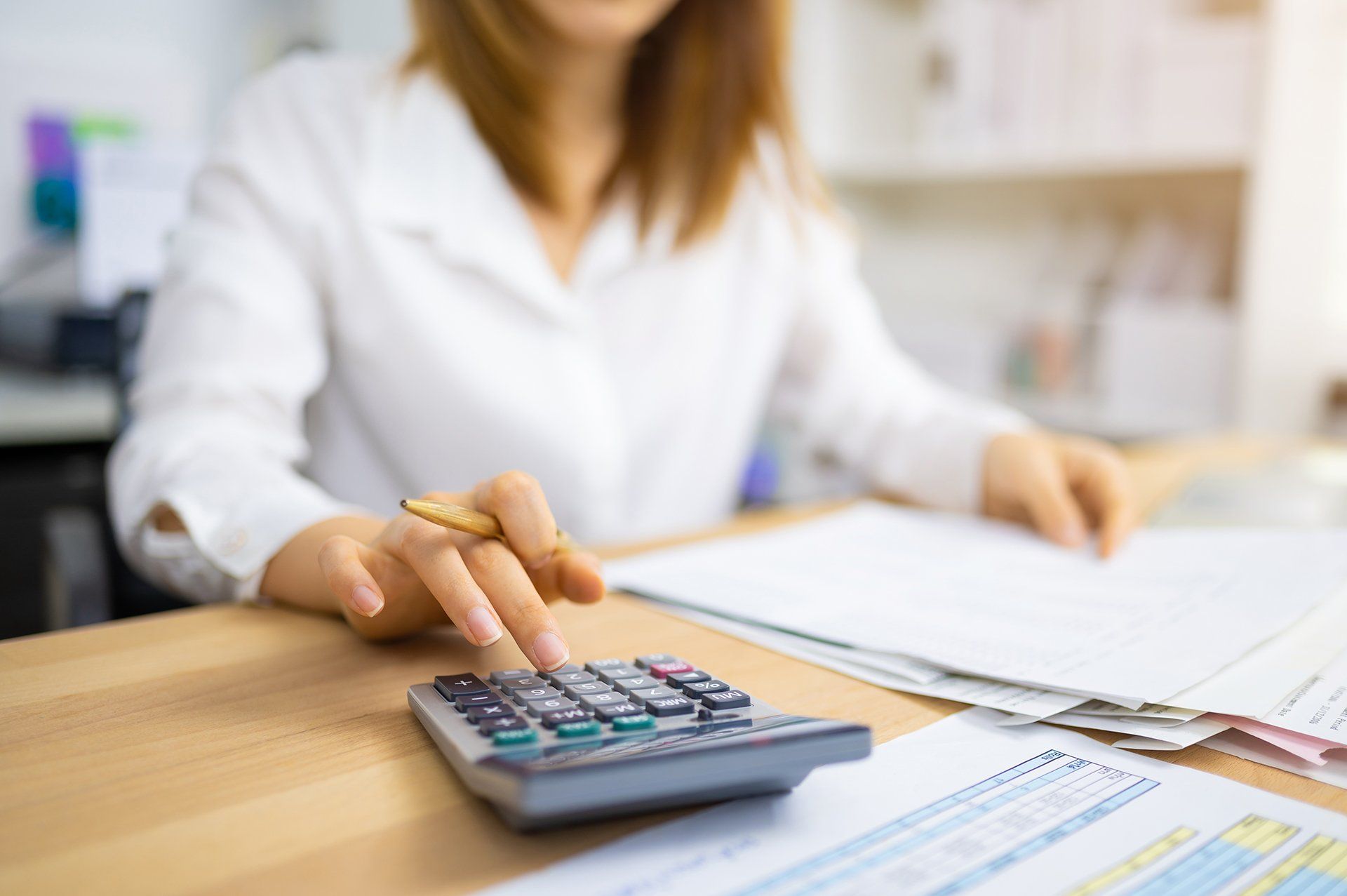 Accountant Using Calculator — Traverse City, MI — Traverse Tax Accounting