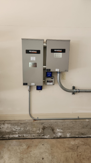 Two electrical boxes are hanging on a wall in a garage.