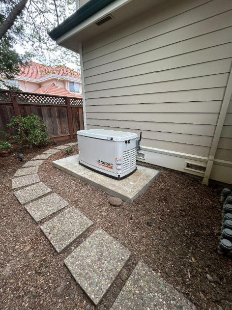 A generator is sitting in the backyard of a house.