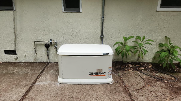 A generator is sitting on the side of a house.