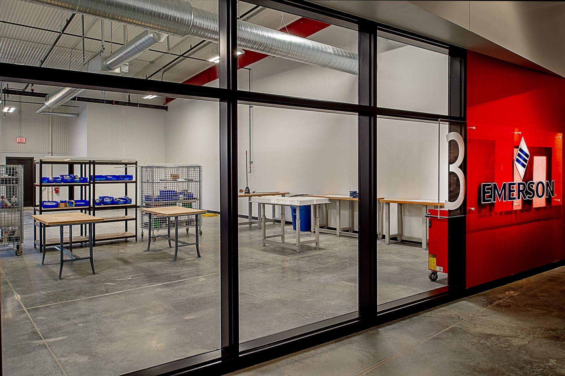 A large room with tables and shelves and the number 3 on the wall