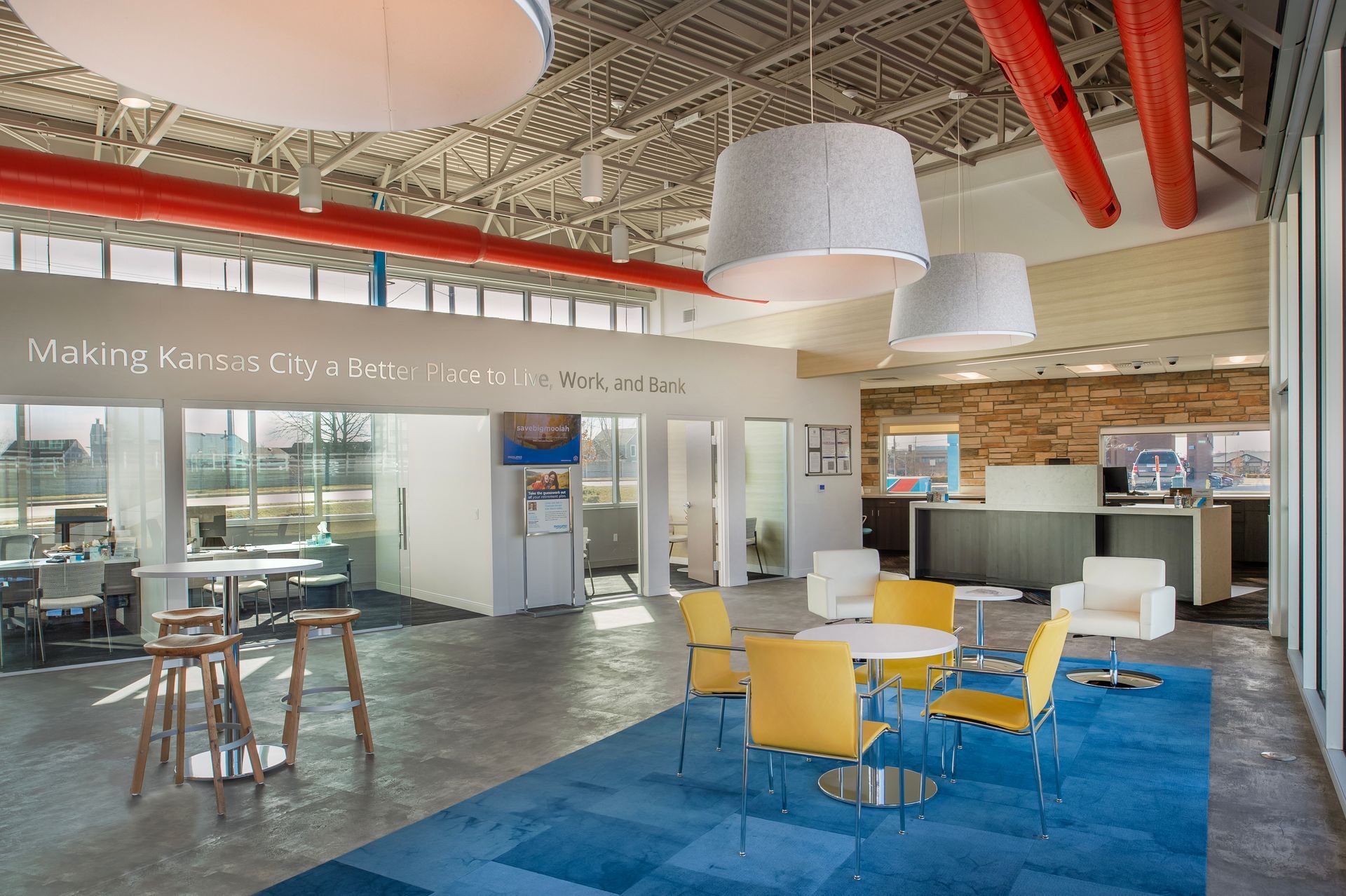 A room with tables and chairs and a sign that says making a difference