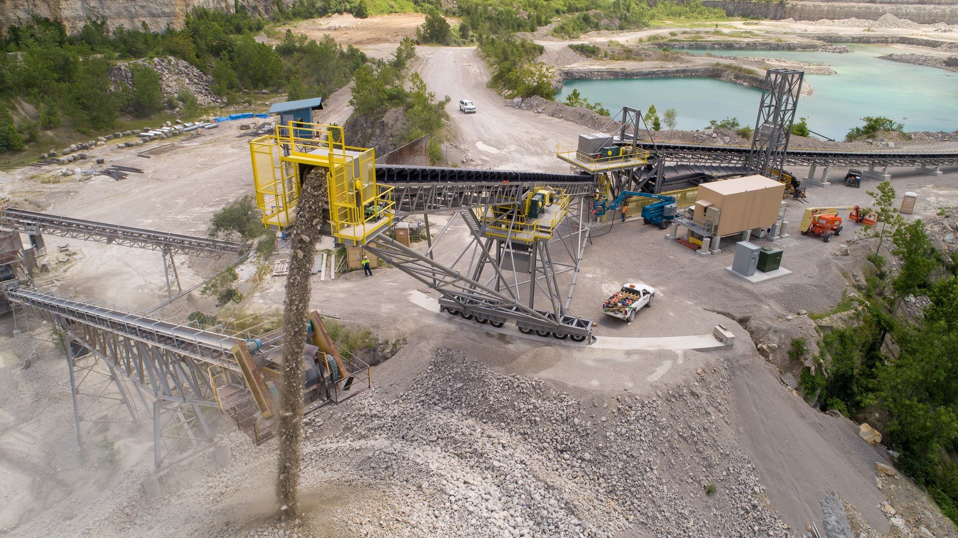 An aerial view of a large rock quarry with a lot of machinery.