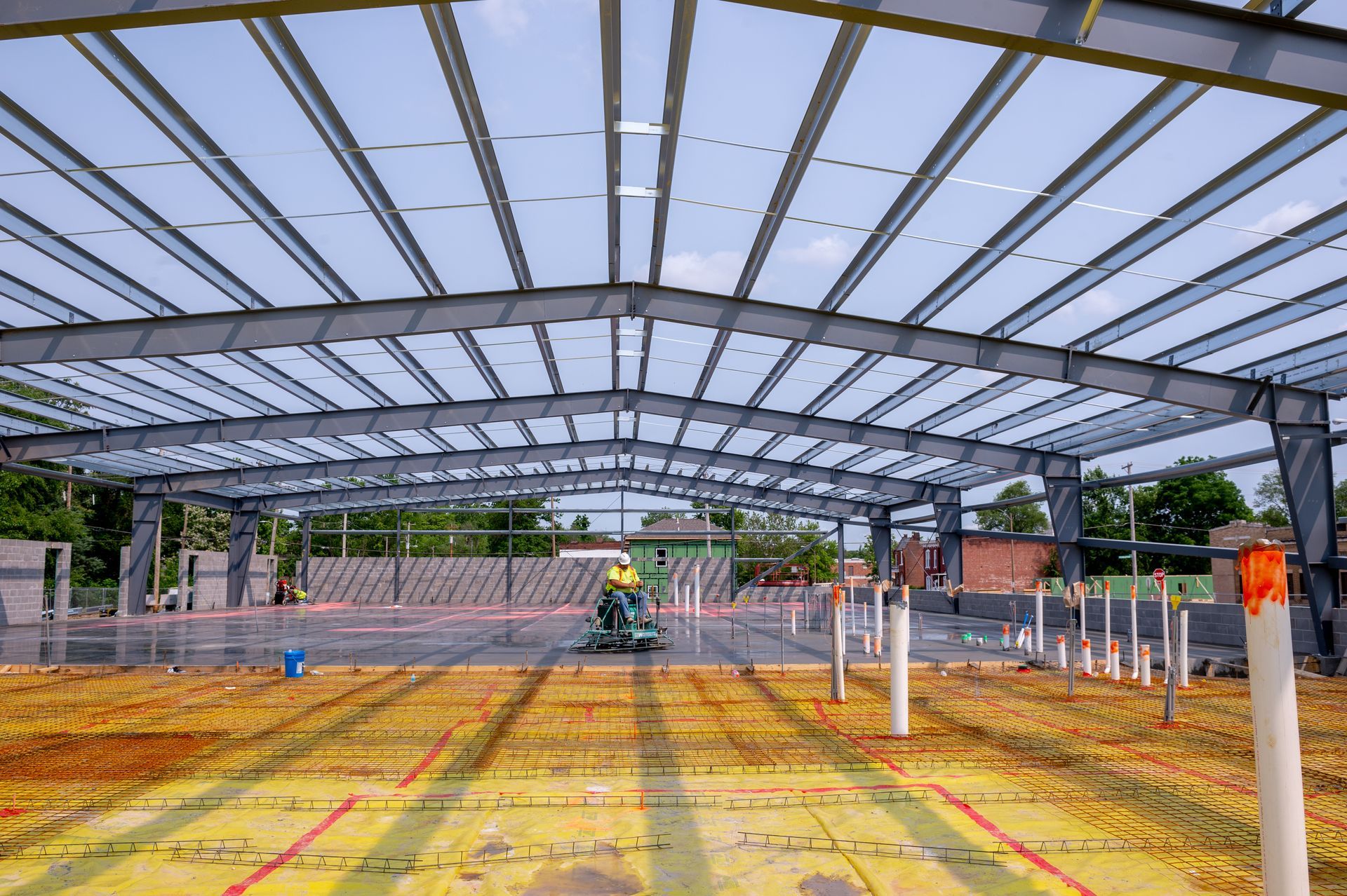 A large metal structure is being built on a construction site.