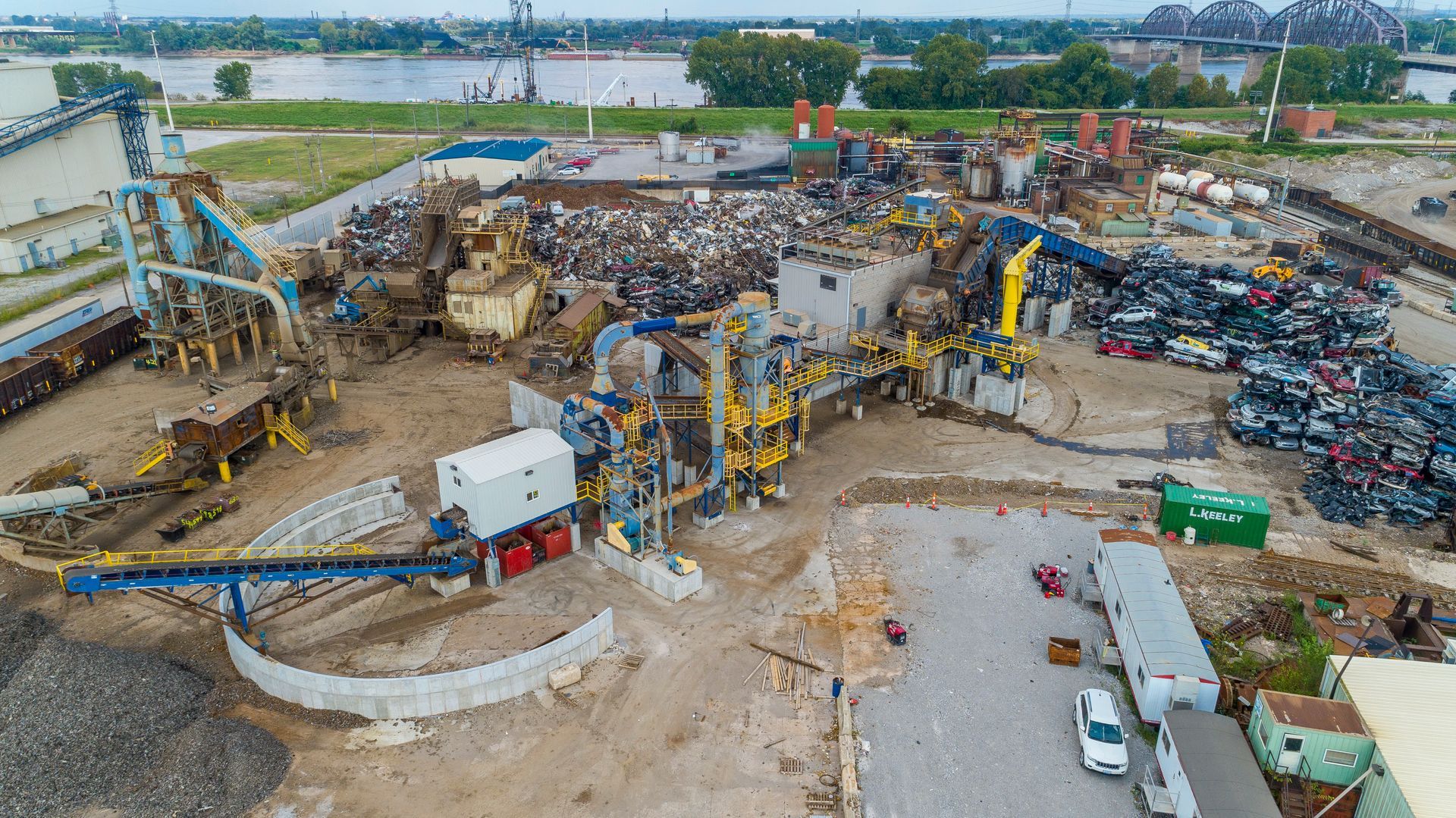 An aerial view of a scrap yard filled with lots of machinery.