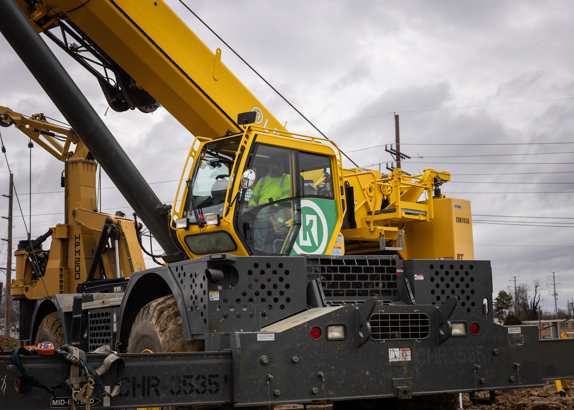 A yellow crane with the letters hr on the side