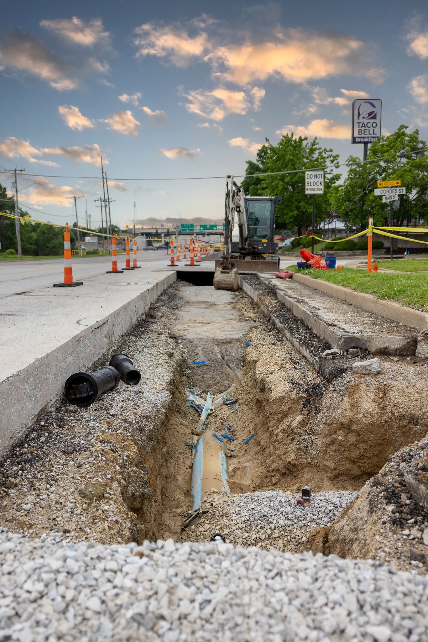 A pipe is being installed in the middle of a road.