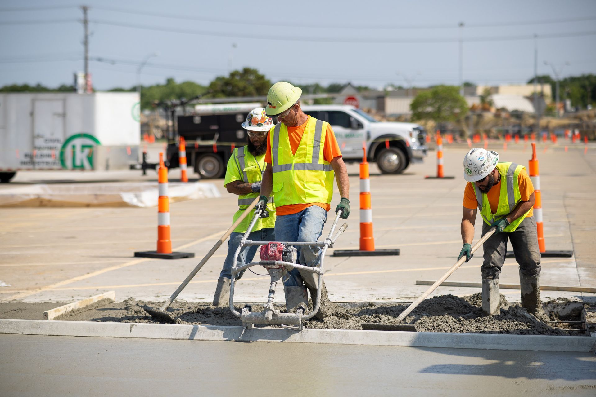 A group of construction workers are working on a road.