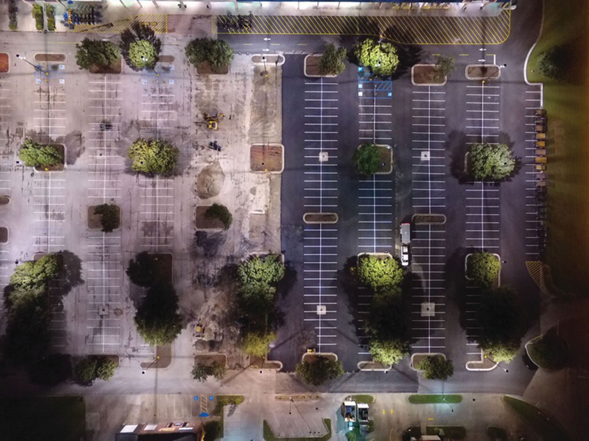 An aerial view of a parking lot at night