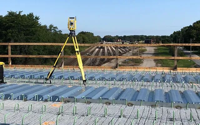 A tripod is sitting on top of a bridge under construction.