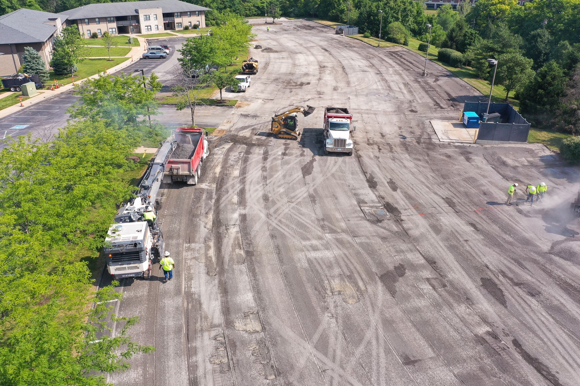 An aerial view of a construction site with trucks and workers.