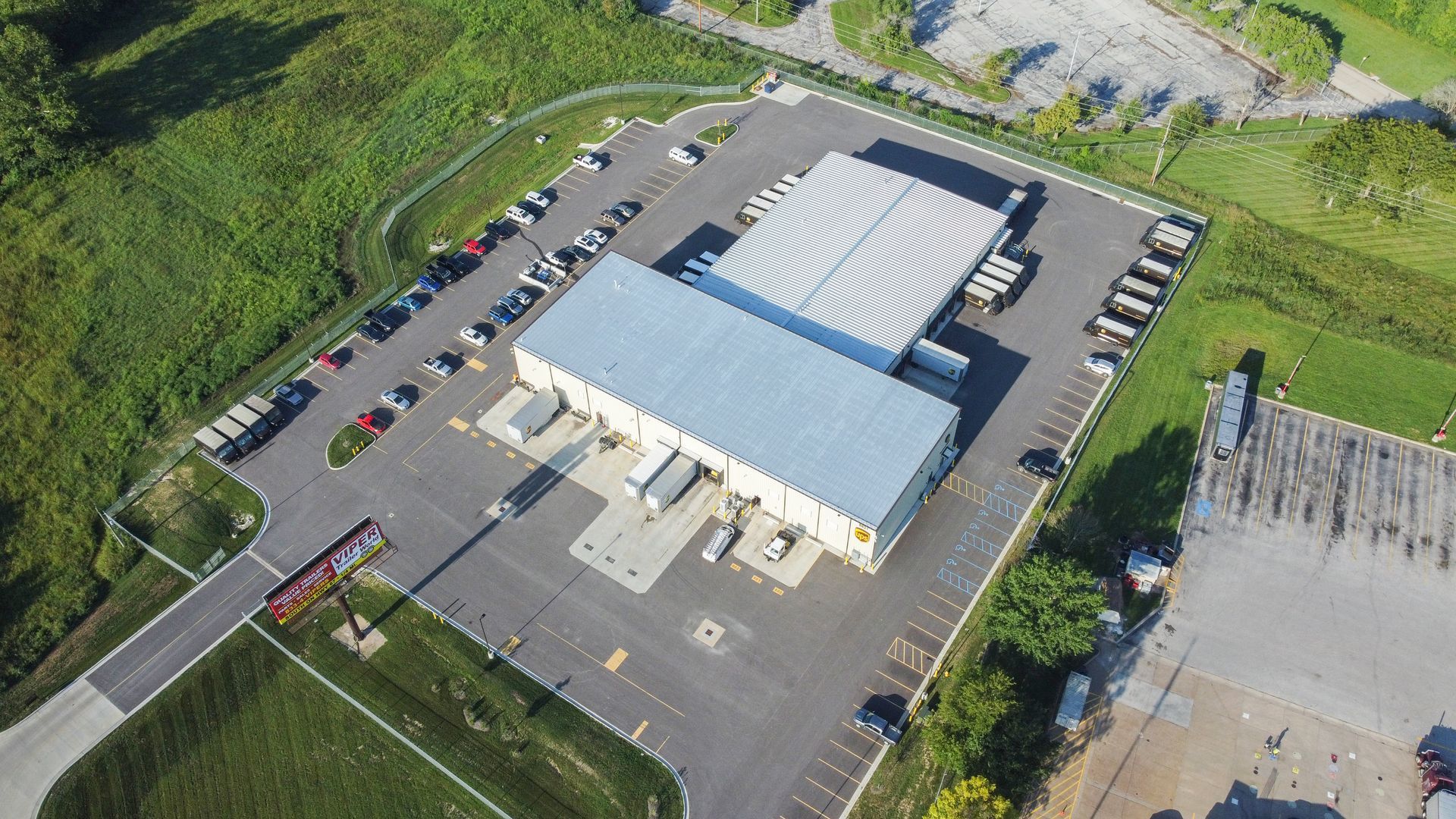 An aerial view of a large building in a parking lot.