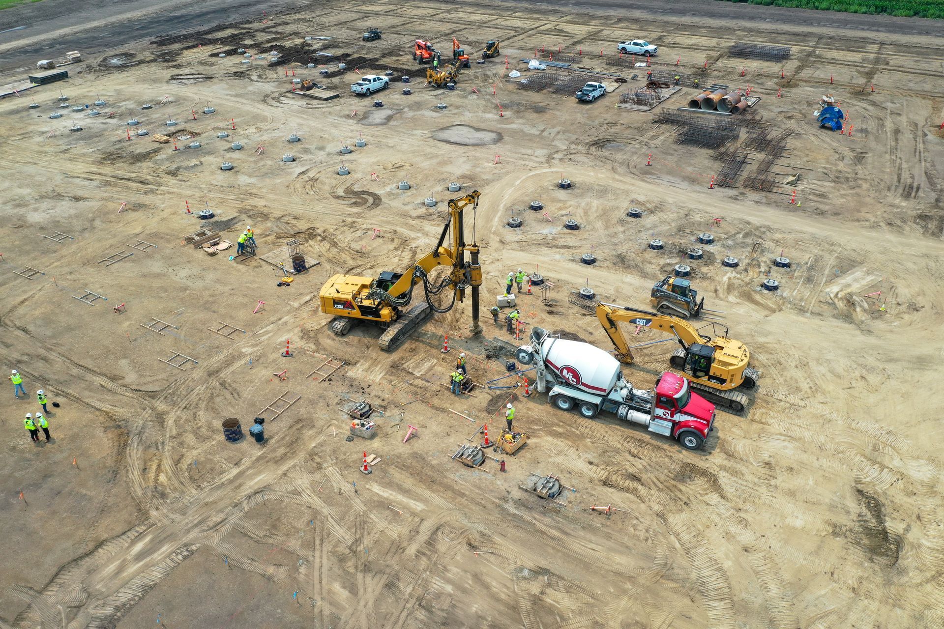 An aerial view of a construction site with a concrete mixer truck.