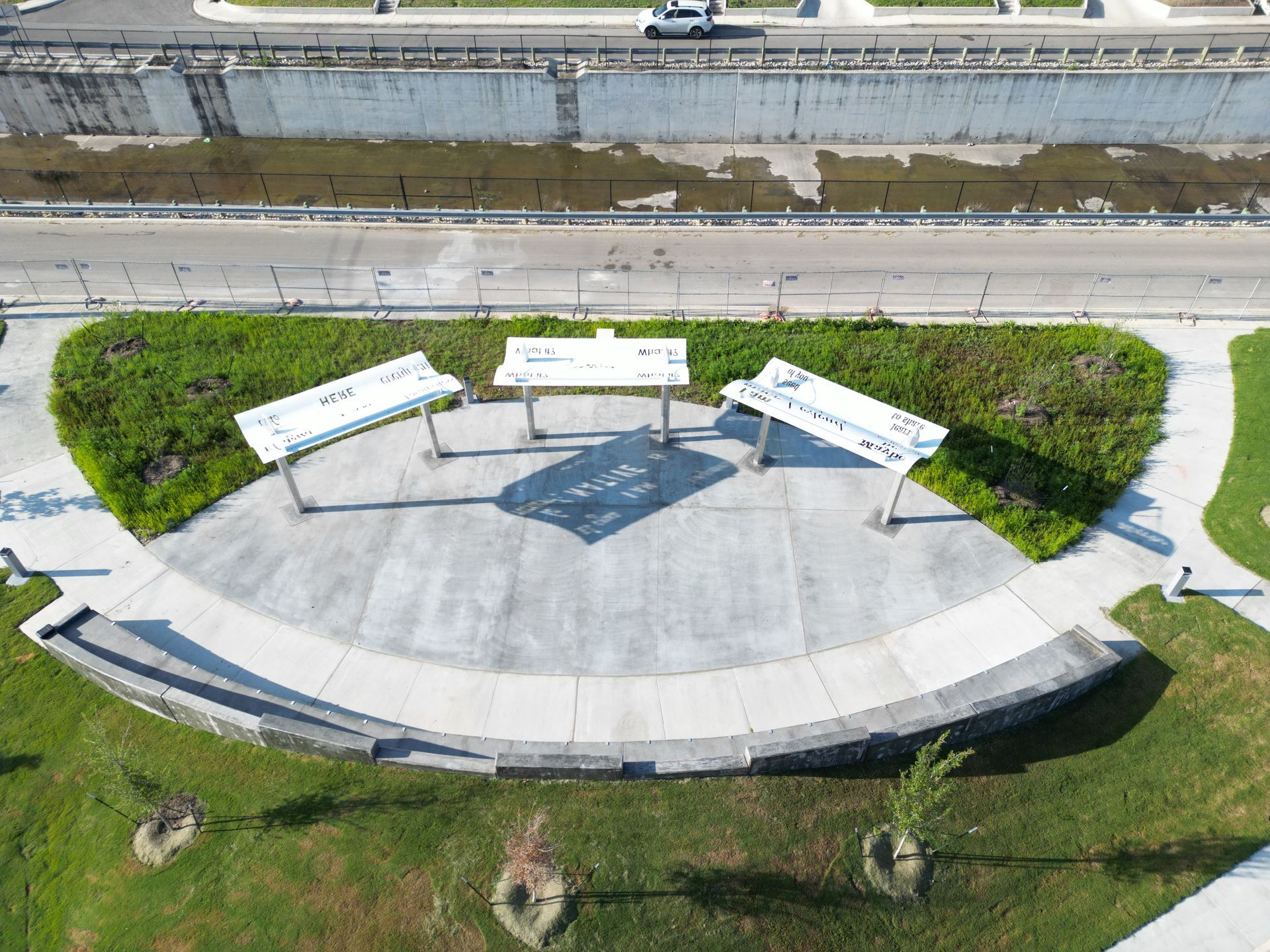 An aerial view of a park with tables and benches