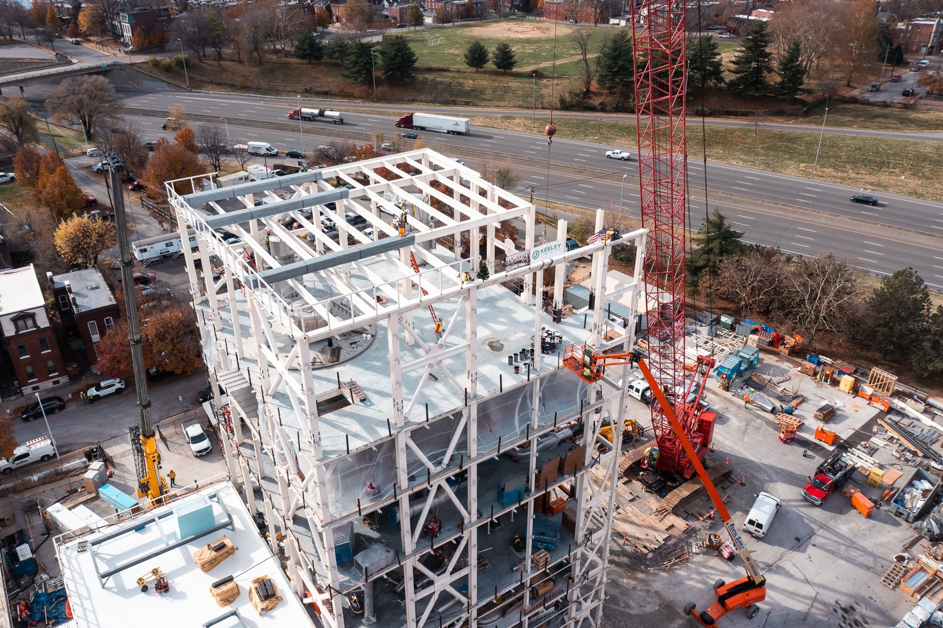 An aerial view of a building under construction in a city.