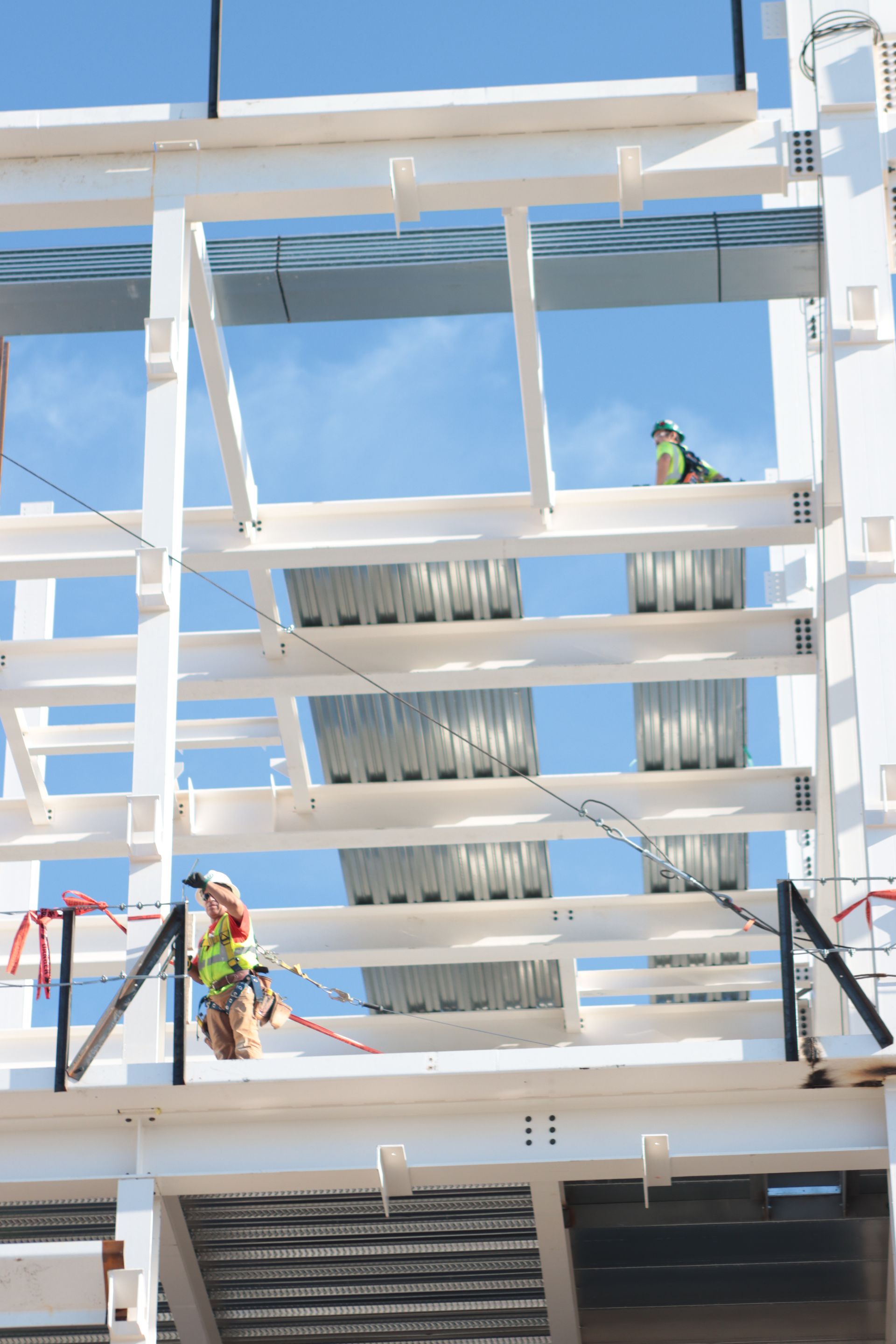 A group of construction workers are working on a building under construction.