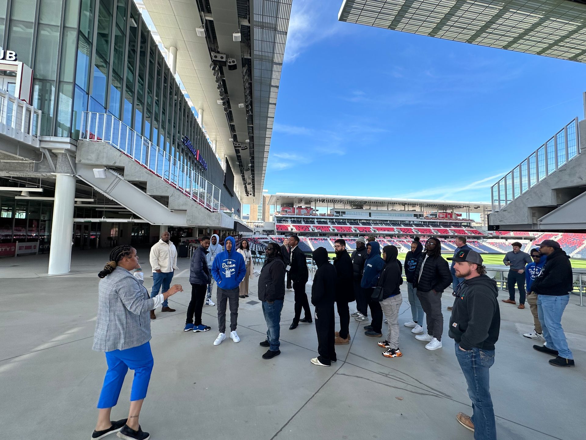 A group of people are standing in front of a large building.
