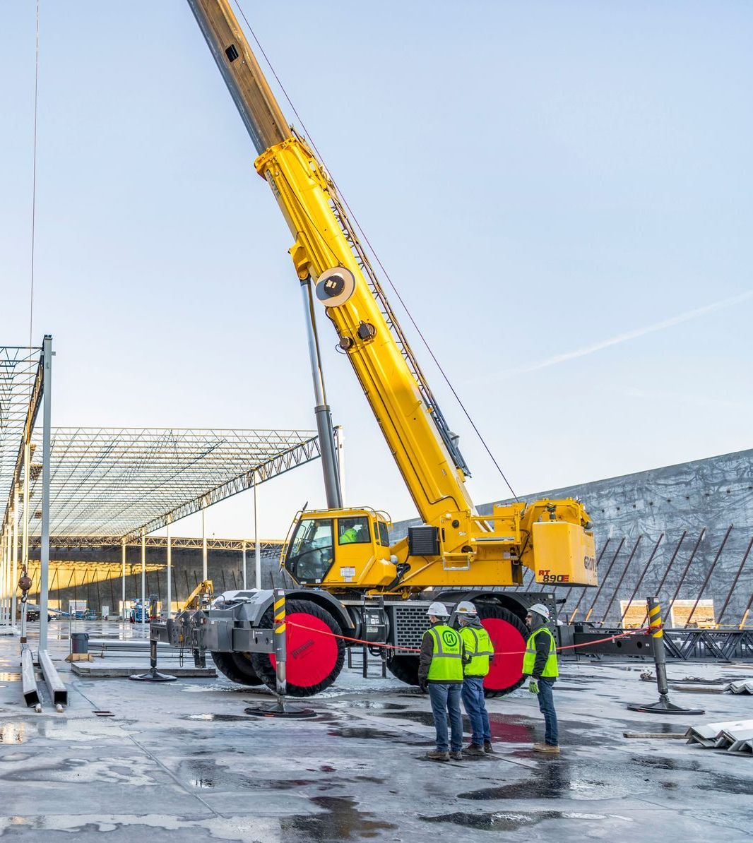 A large yellow crane is being used on a construction site.