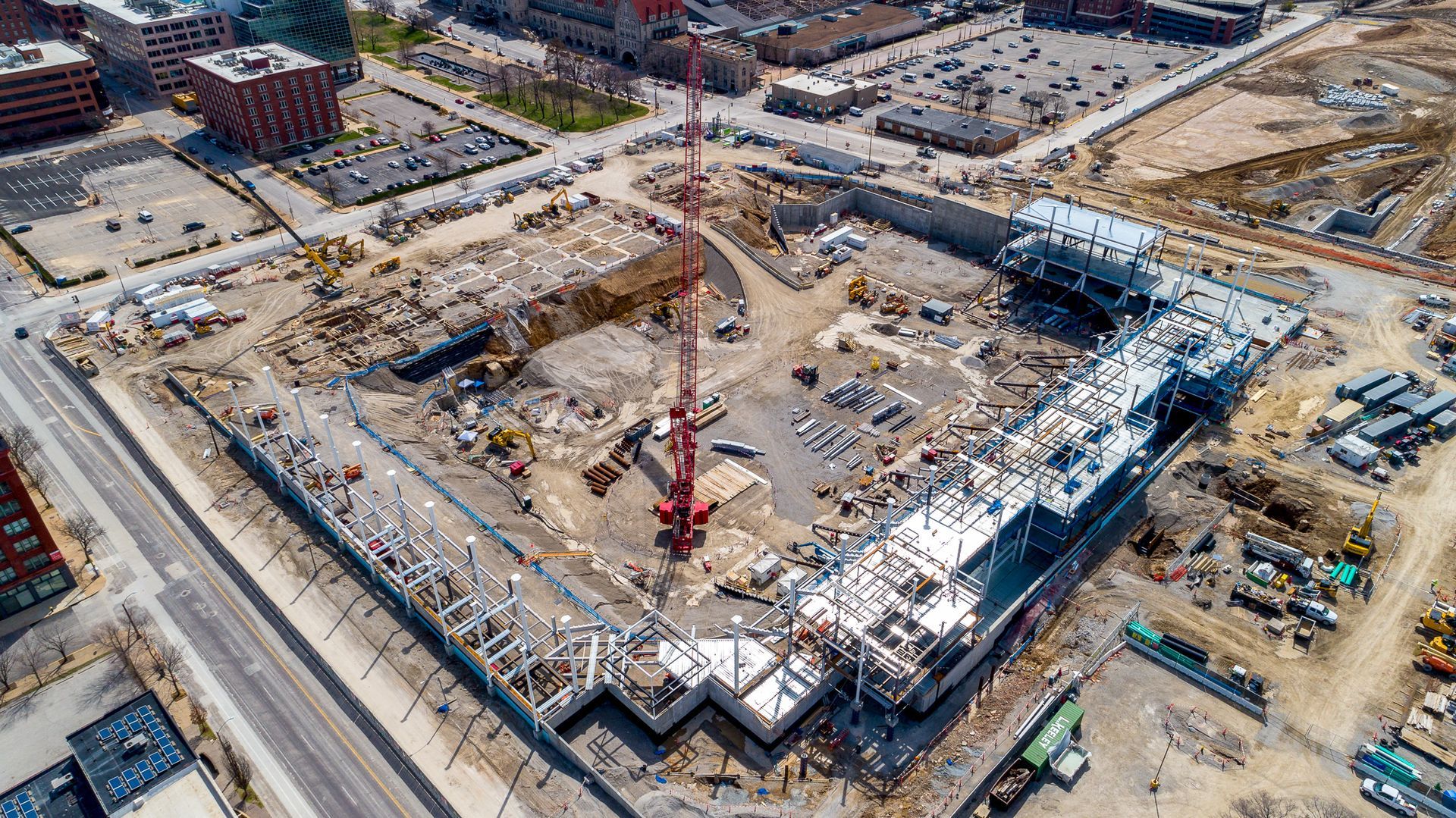 An aerial view of a large building under construction in a city.