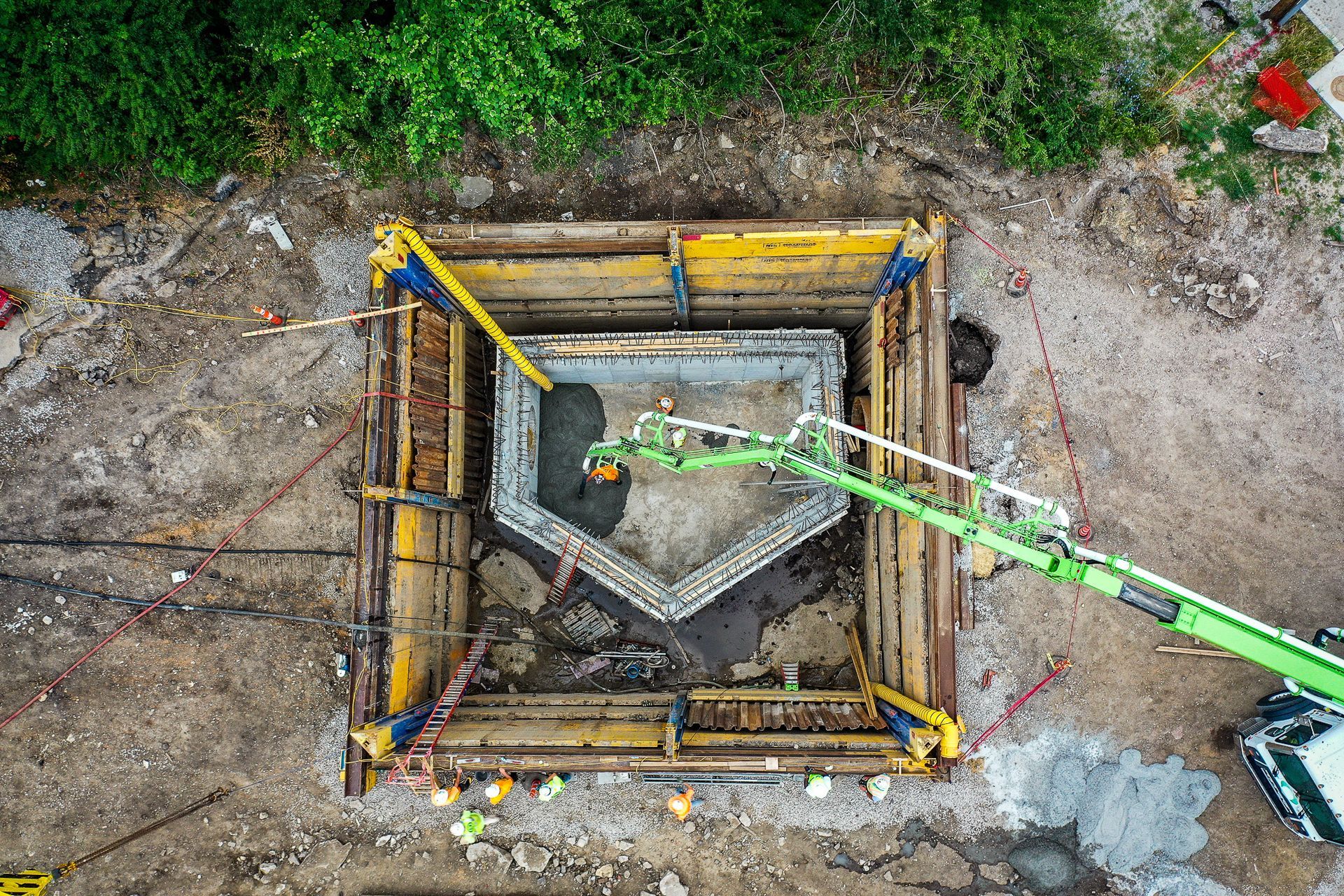 An aerial view of a construction site with a green crane.