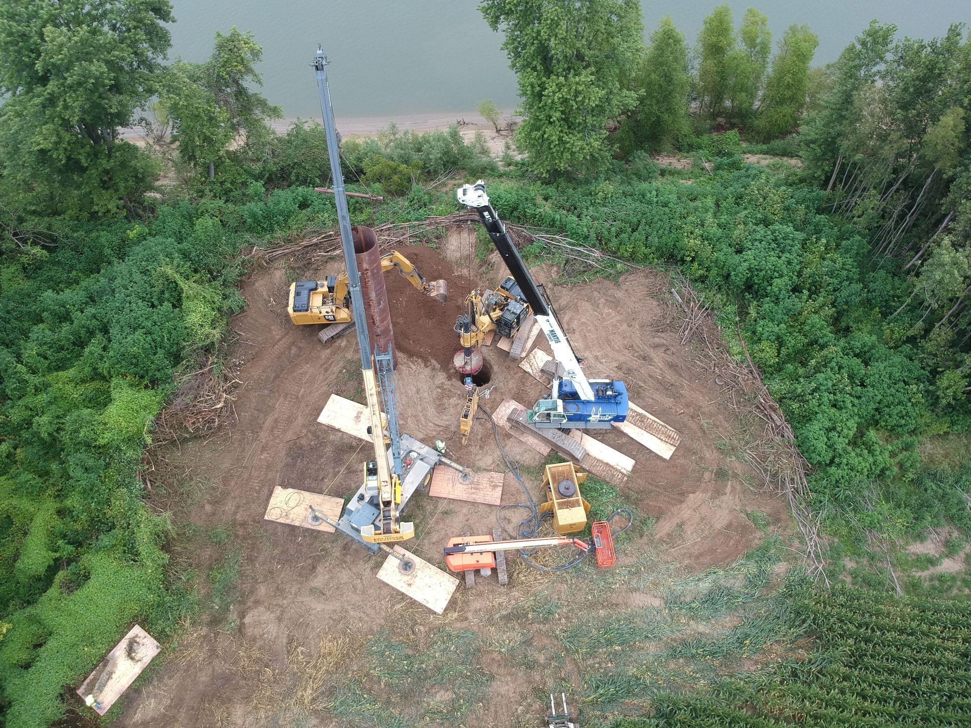 An aerial view of a construction site next to a body of water.