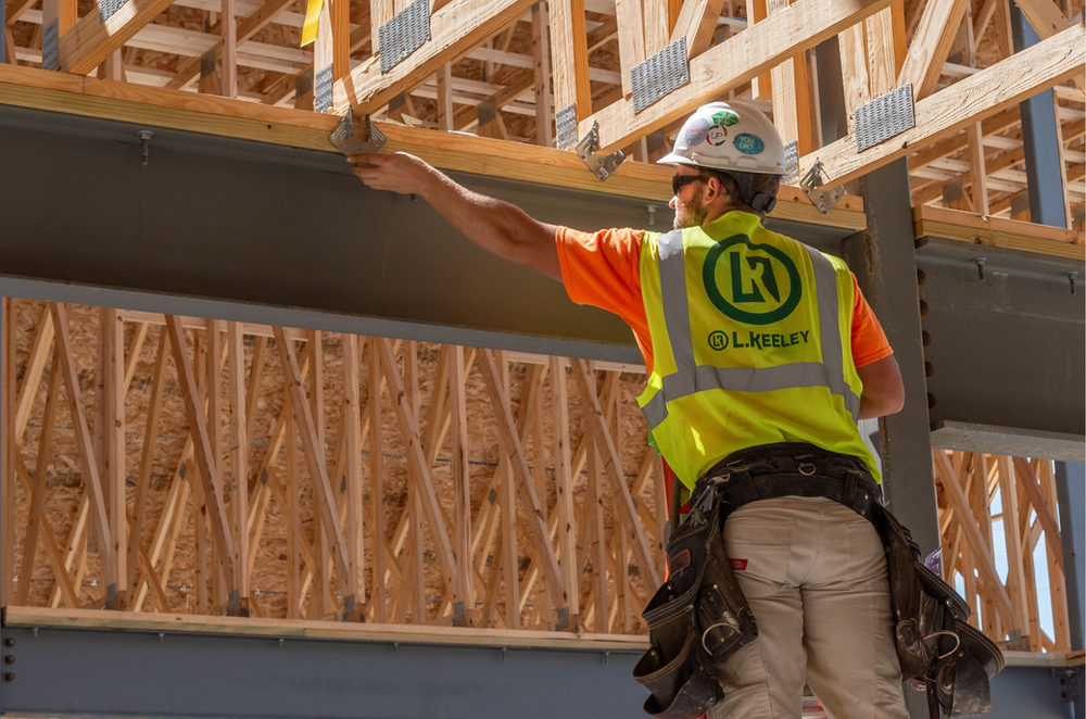 A construction worker is working on a building under construction.