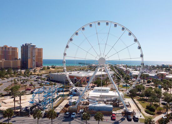 An aerial view of a ferris wheel in a city.