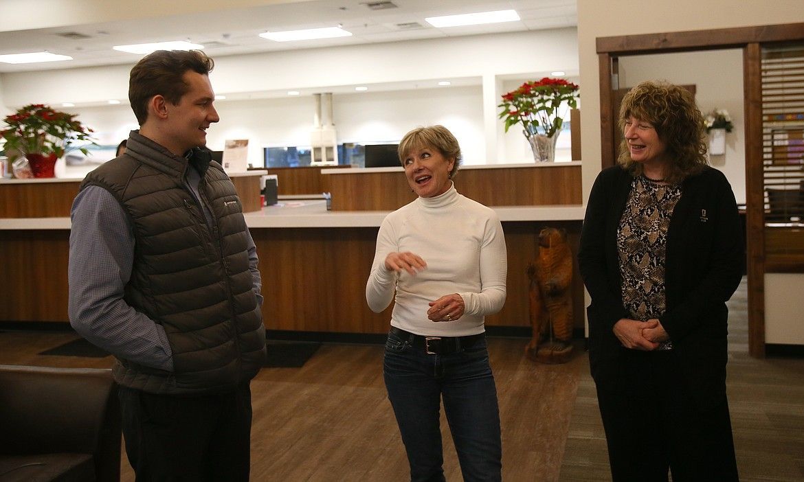 Connor Skinner of Umpqua Bank in Coeur d'Alene visits with Charity Reimagined founder Maggie Lyons, center, and Charity Reimagined board member and fellow Umpqua team member Judy Coe after the bank donated $3,500 Tuesday afternoon to support CharityTracker.
