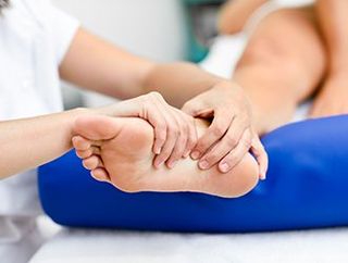 Foot Pain — Doctor Massaging Patient's Foot in East Longmeadow, MA