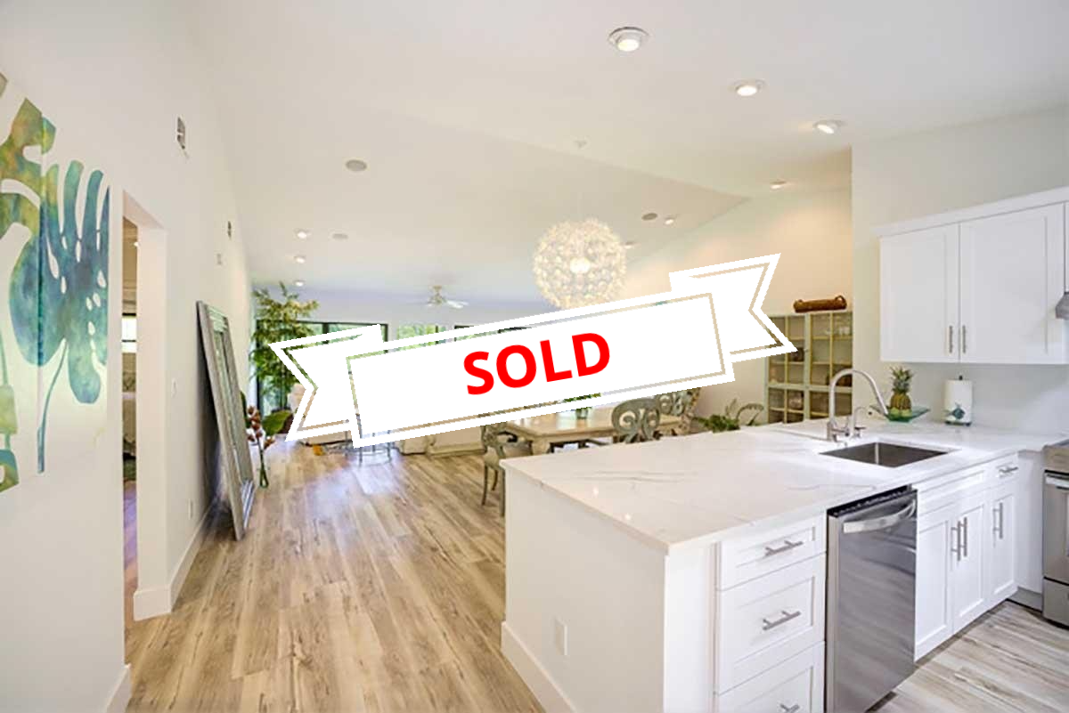A kitchen with a sign that says sold on it