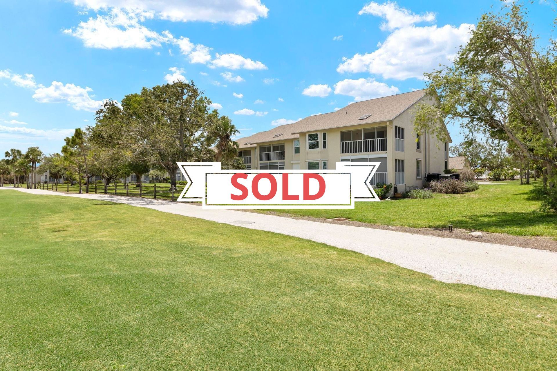 A house with a sold sign in front of it.