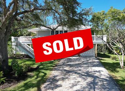 A house with a sold sign in front of it