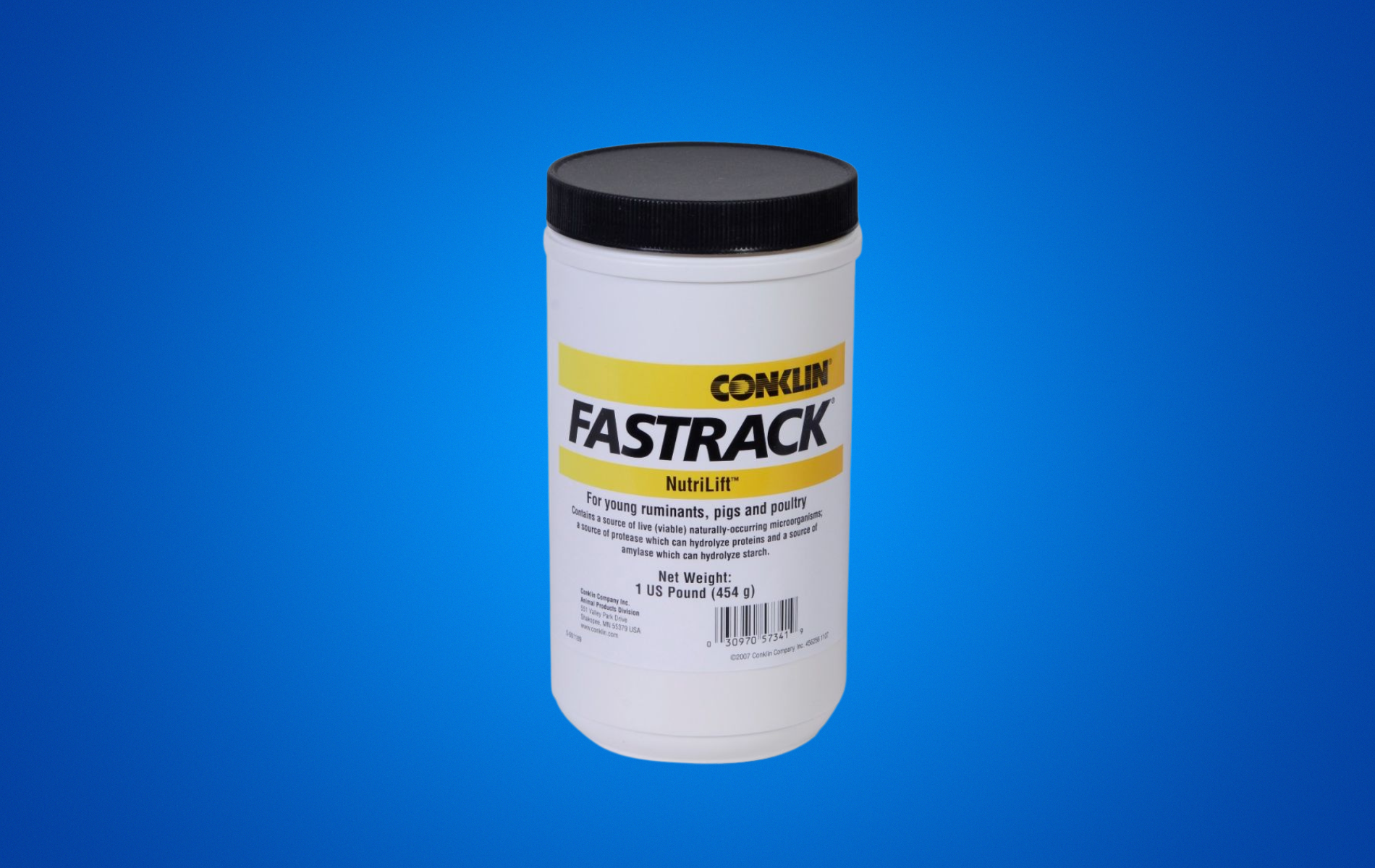 A jar of fastrack lubricant is sitting on a blue surface.