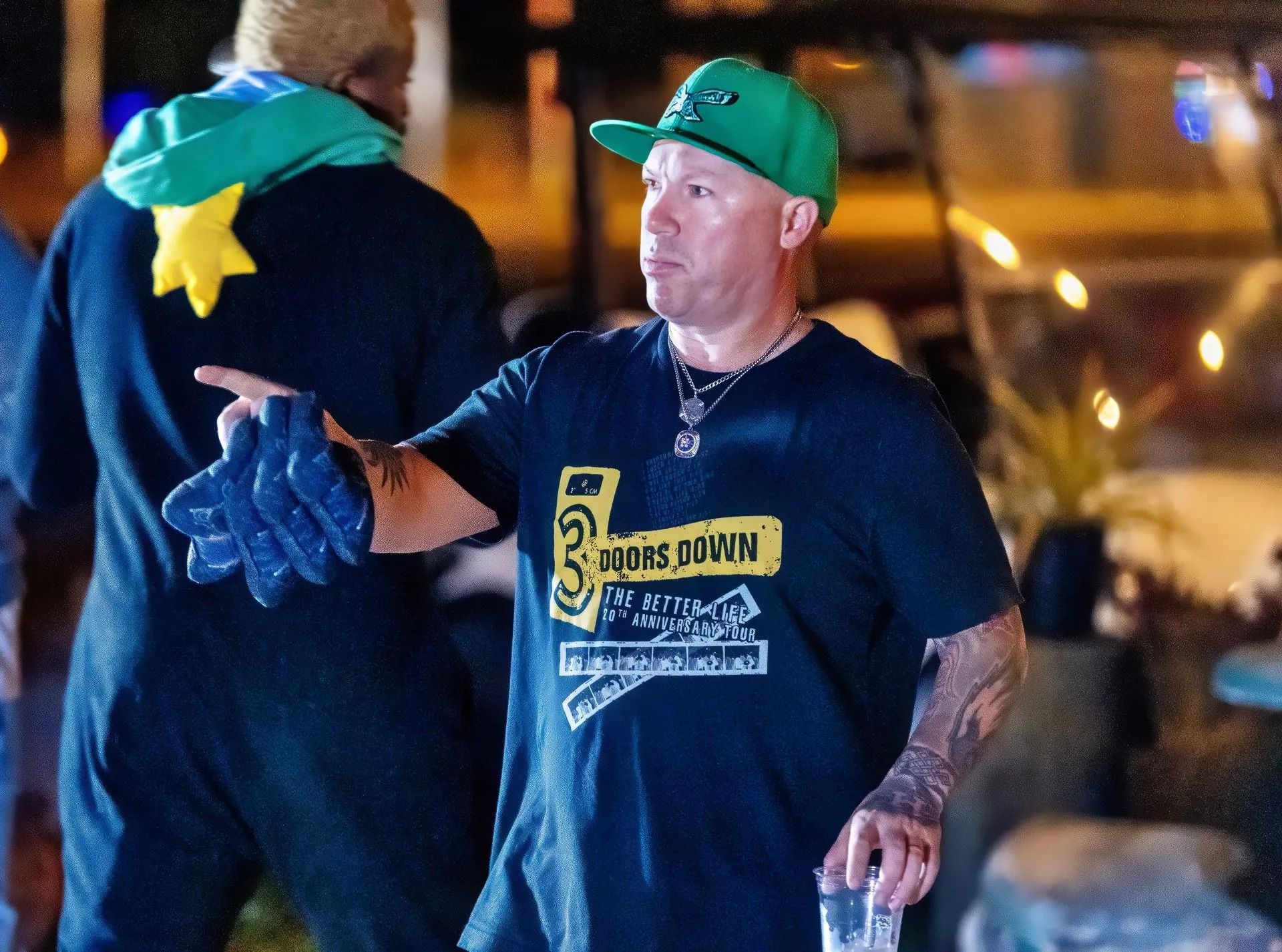 A man wearing a hat and a t-shirt that says water sport