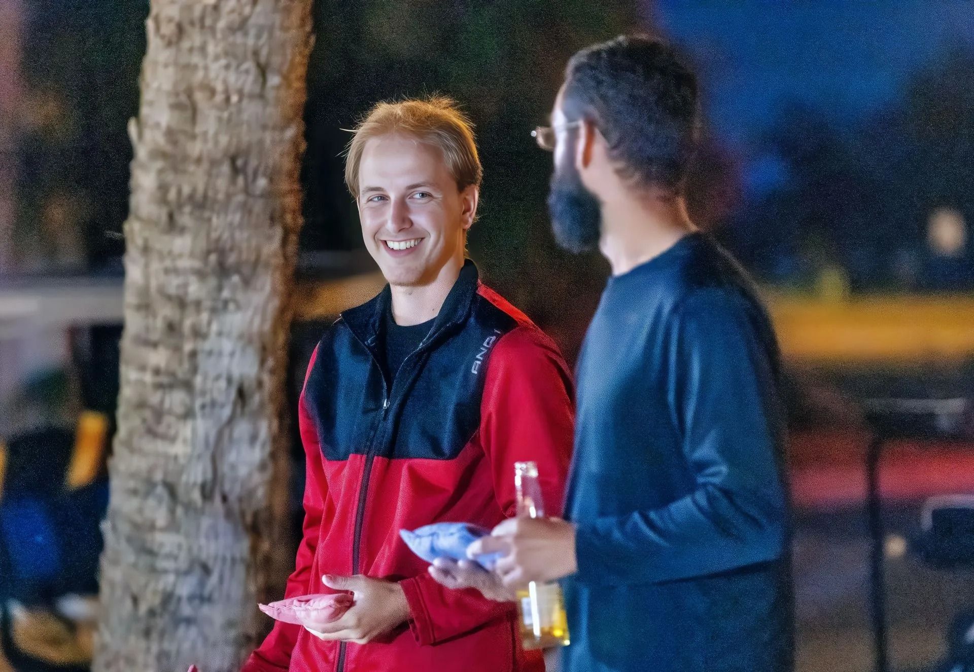 Two men are standing next to each other and smiling.