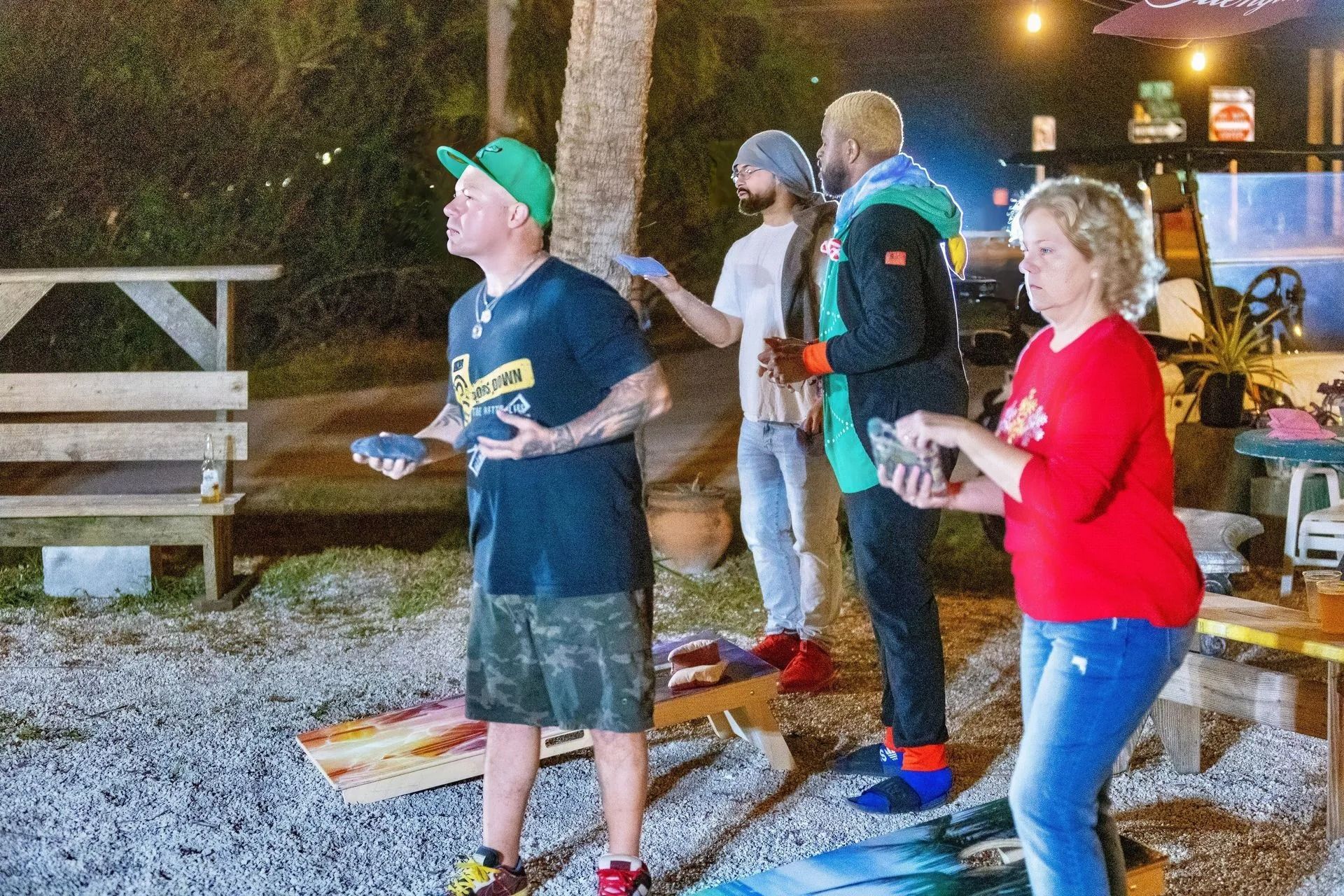 A group of people are standing around a table playing a game.