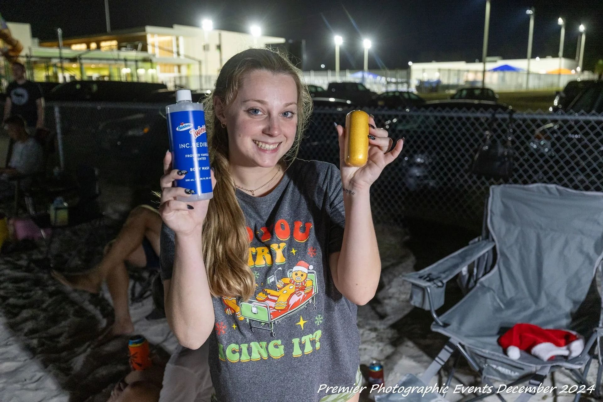 A woman is holding a cup and a can of soda.