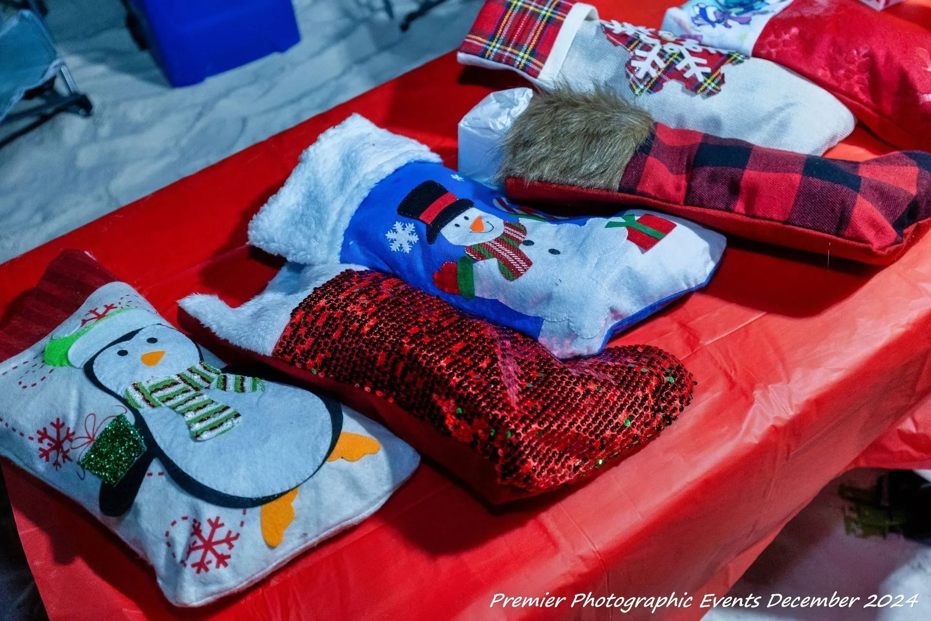 A bunch of christmas stockings are sitting on a table