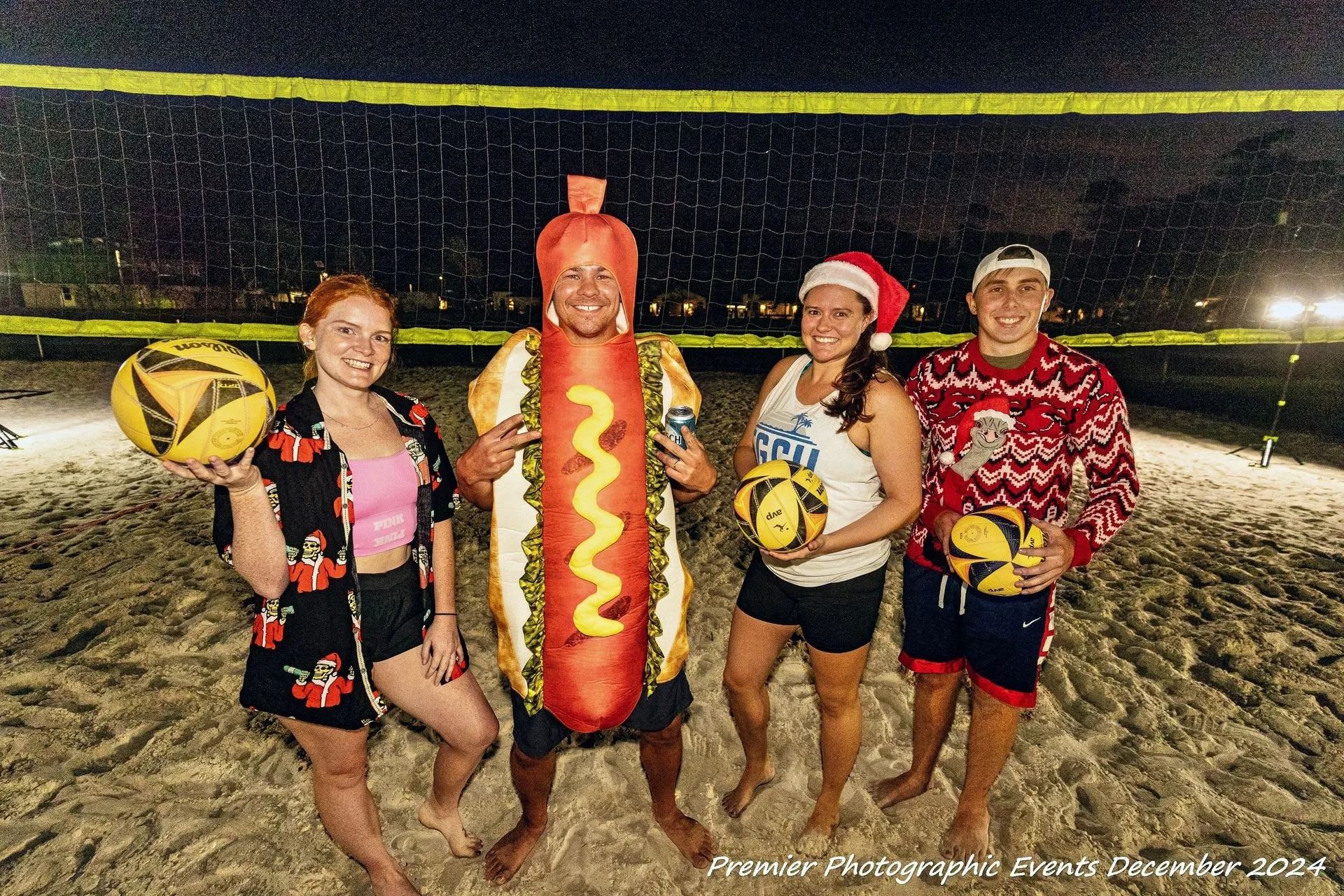 A group of people posing for a picture on the beach