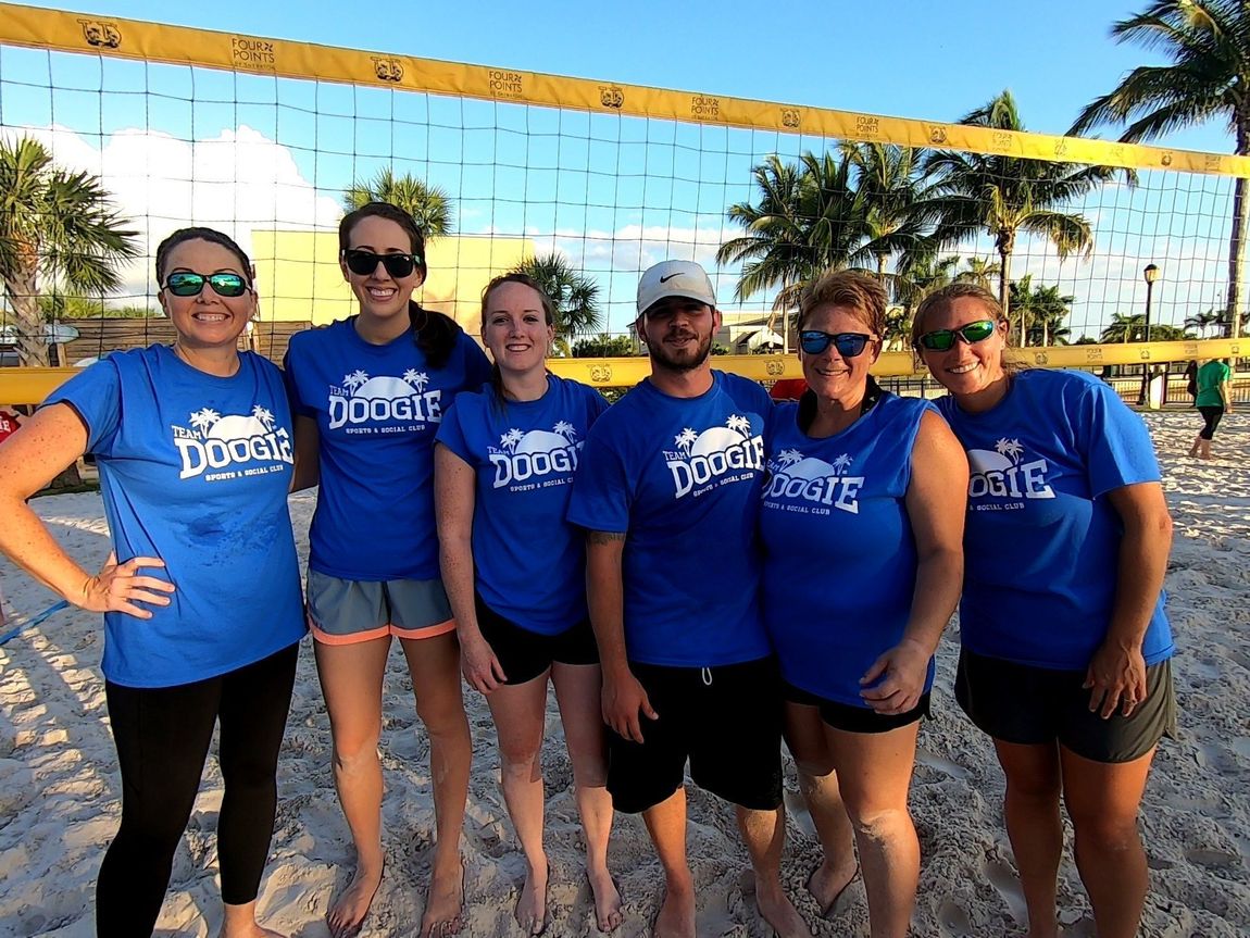 A group of people wearing blue shirts with the word doogie on them