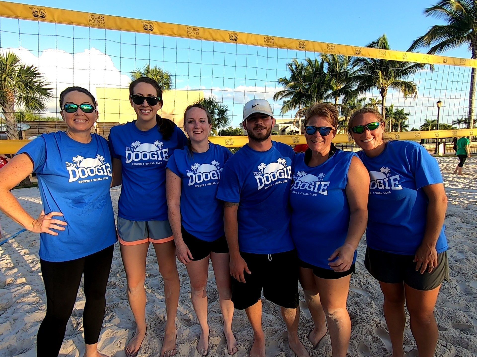 A group of people wearing blue shirts with the word doogie on them