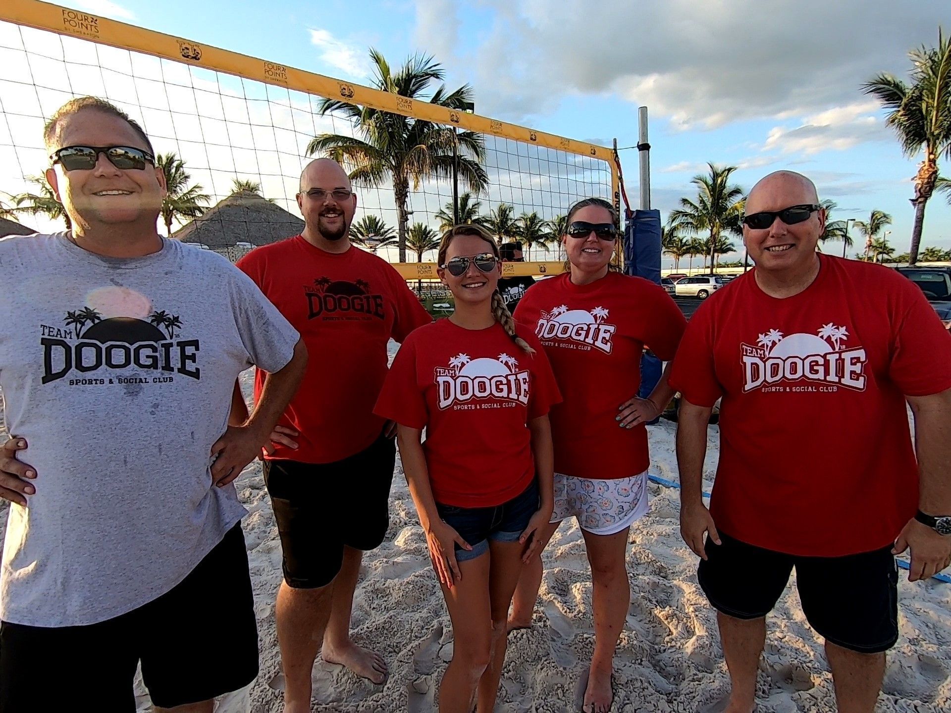 A group of people wearing red shirts with the word doogie on them