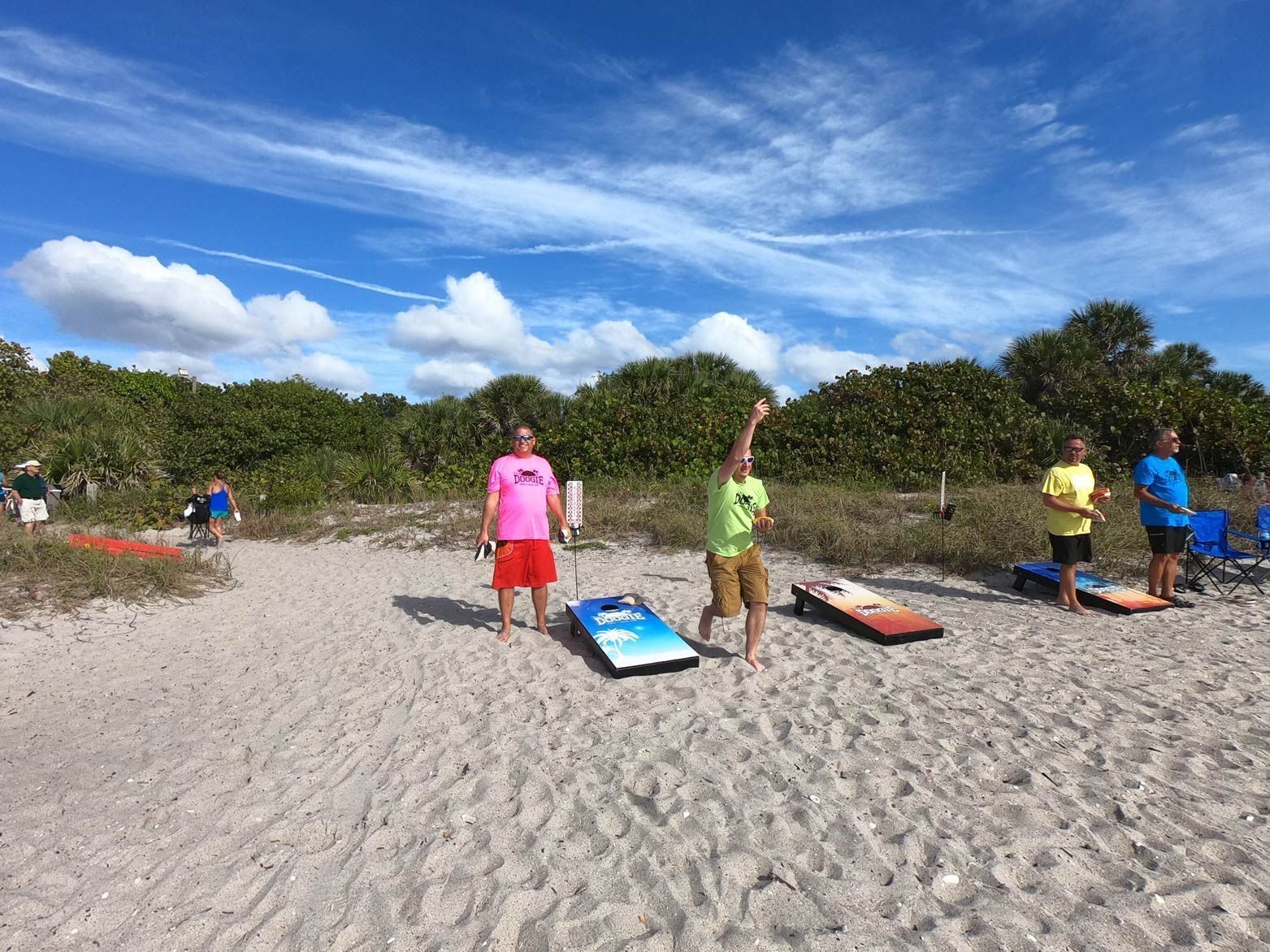 A group of people are playing a game on the beach.