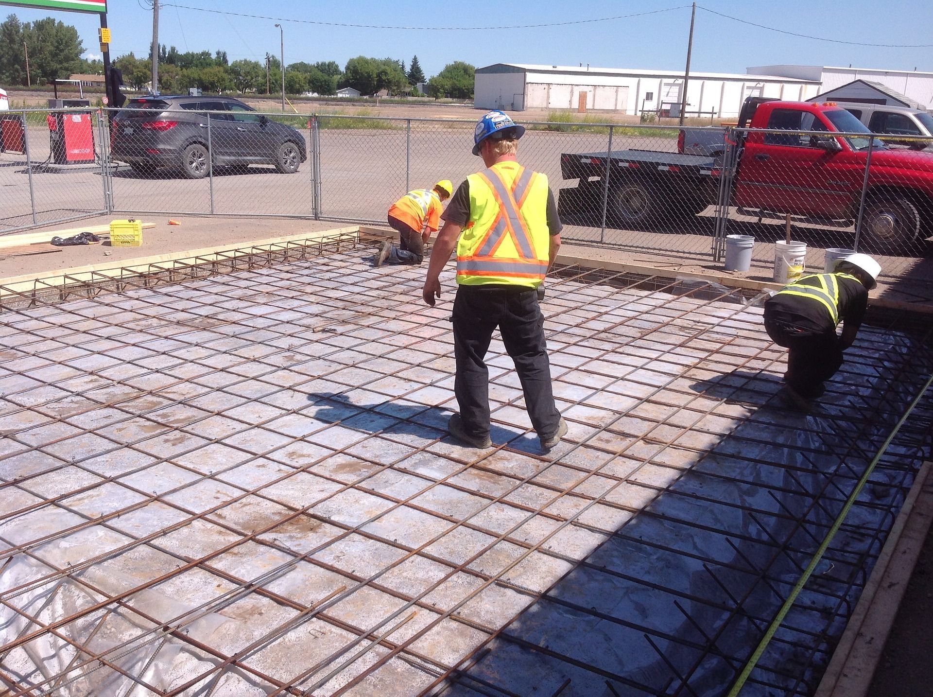 men laying reinforcement for a concrete slab