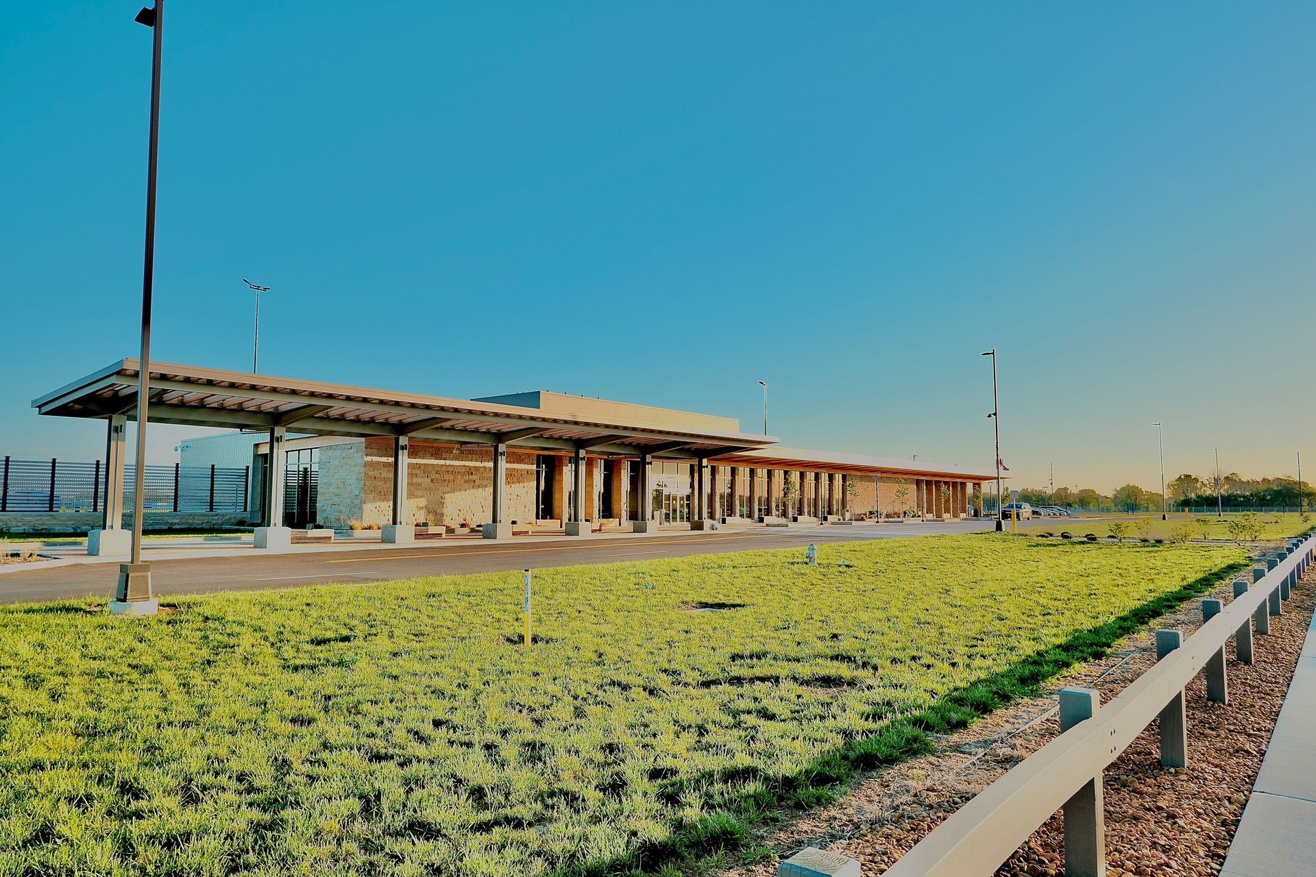A large building with a lot of green plants in front of it