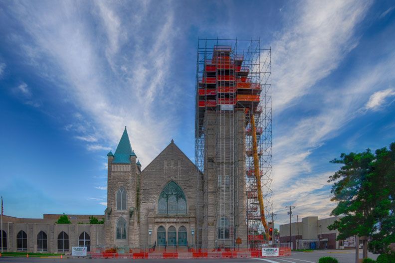 A large church is being built with scaffolding around it.